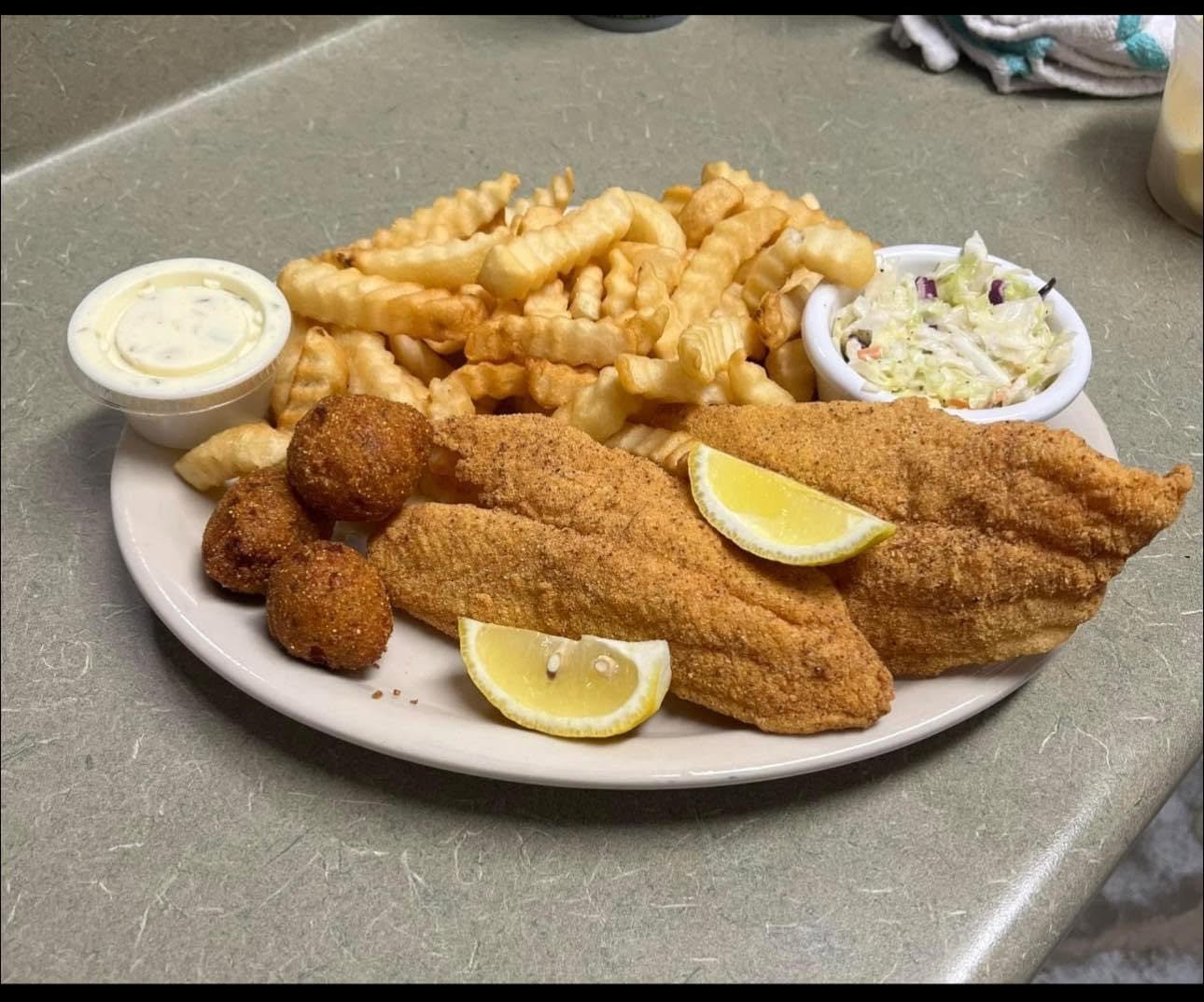 Fried catfish platter with fries, hush puppies and coleslaw